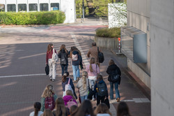 A group of girls walks across the campus