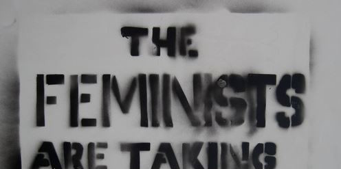A spray-painted lettering ‘The Feminists are taking over!’ 