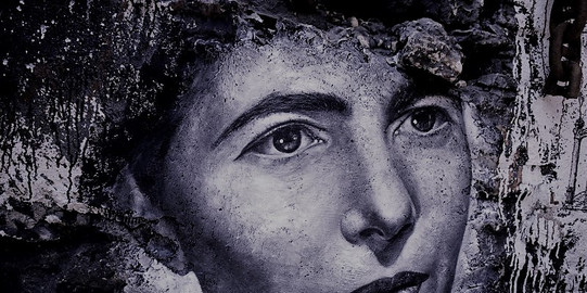 A spray-painted portrait of Simone de Beauvoir on a wall