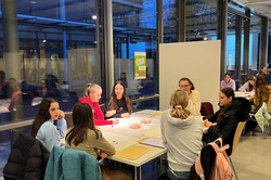 A MinTU group is sitting around a table. 