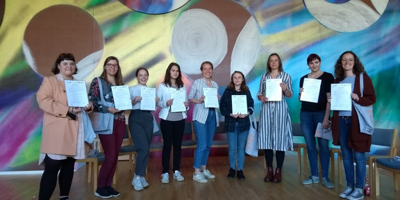 The participants show their certificate