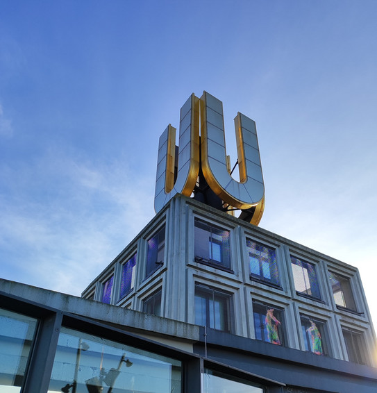 Von unten fotografiert: das Gebäude "Dortmunder U", auf dessen Dach ein riesiges vergoldetes "U" prangt.