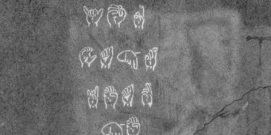You can see painted hands that represent sign language