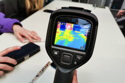 A heat sensor shows handprints on a tabletop