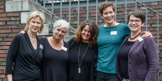 Five women stand together for a group picture.