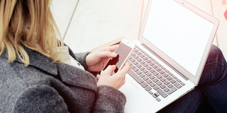 A woman has a laptop on her lap