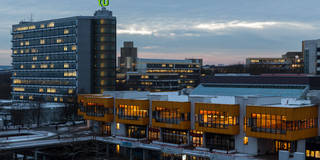 North Campus in the winter Maths Tower and dining hall at dusk in winter.